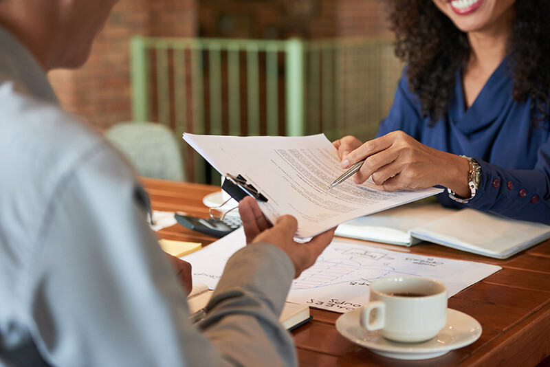 Woman passing insurance policy papers