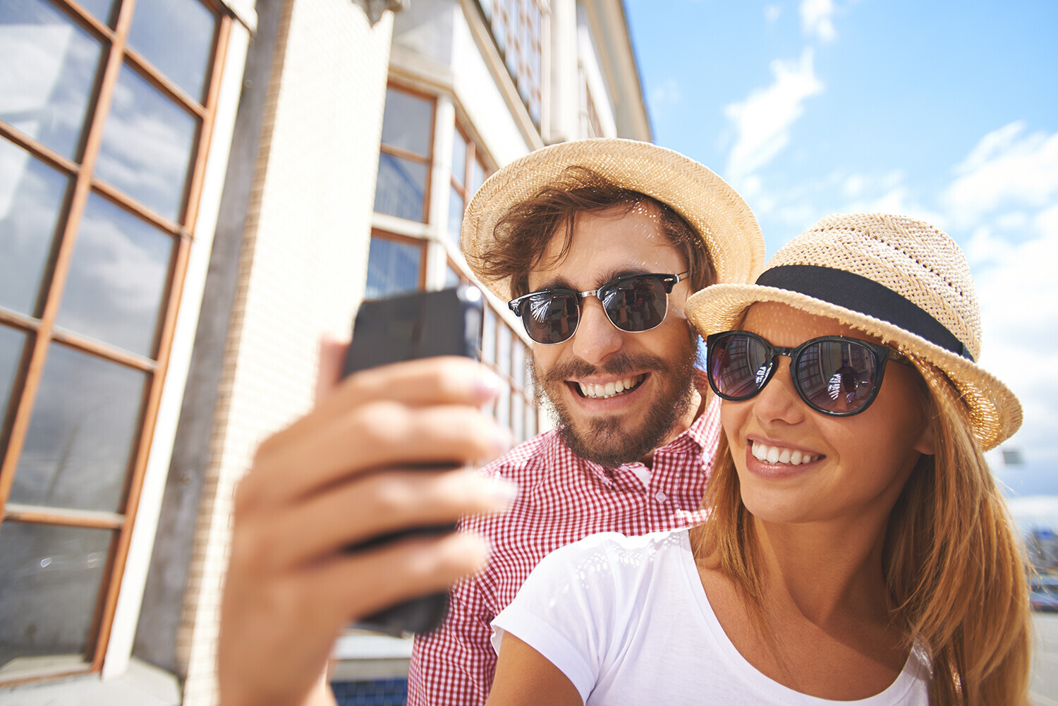 Happy couple taking a picture outside