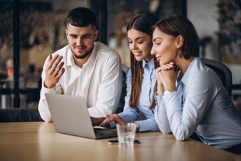 Group of people talking at computer