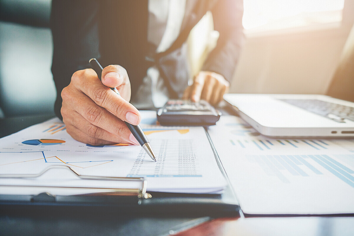 accountant with calculator and paperwork