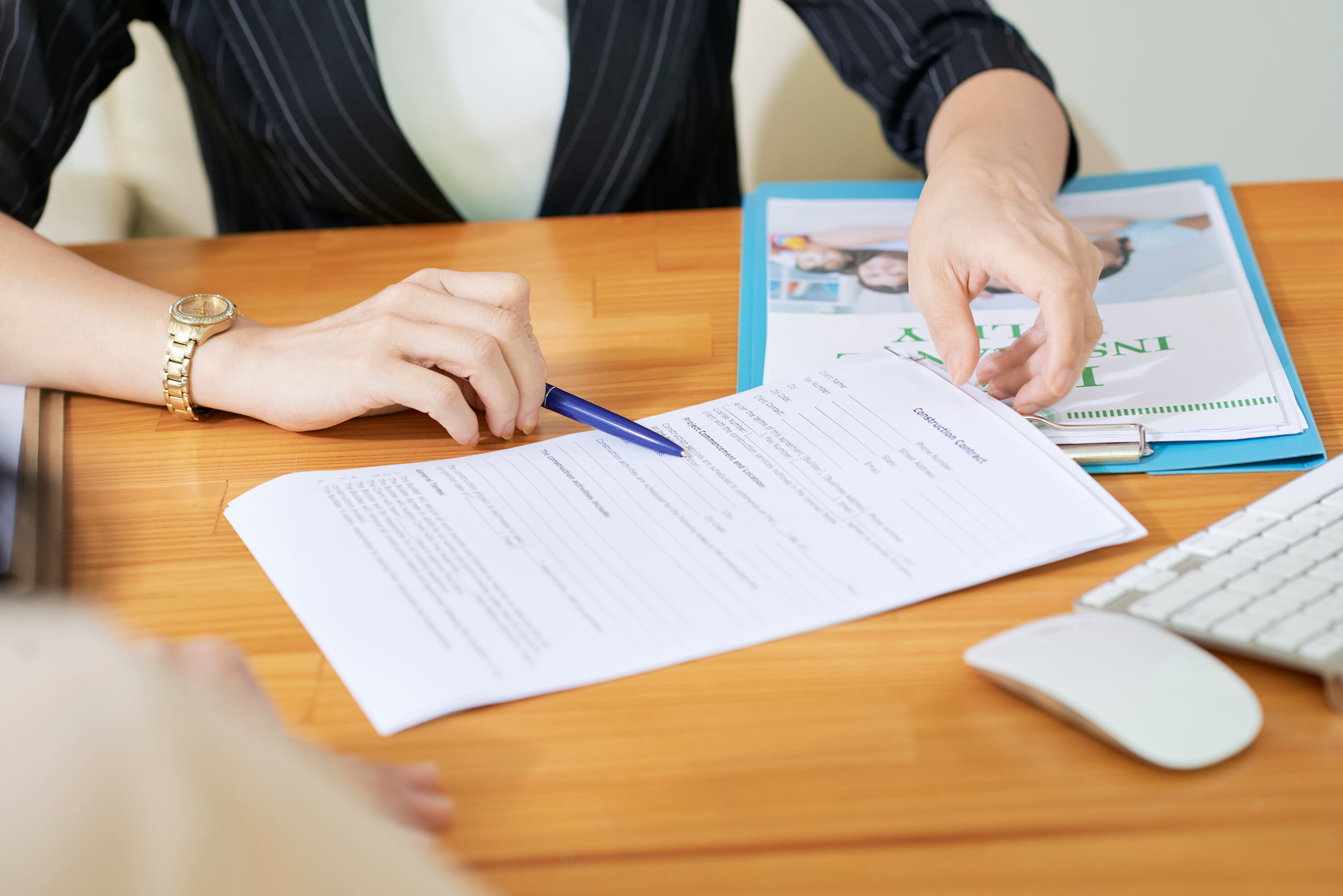 woman with disability insurance policy on table