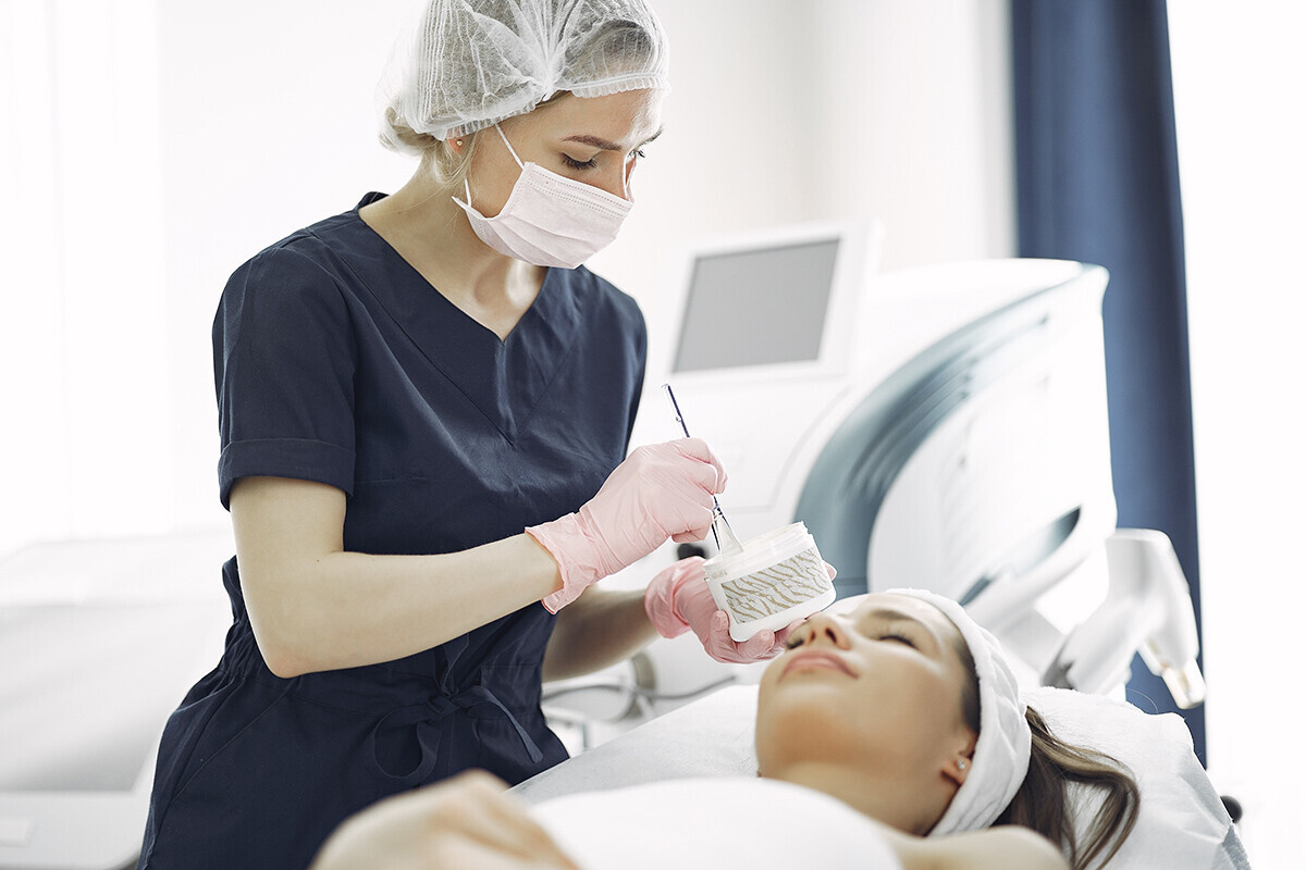 Dermatologist applying cream