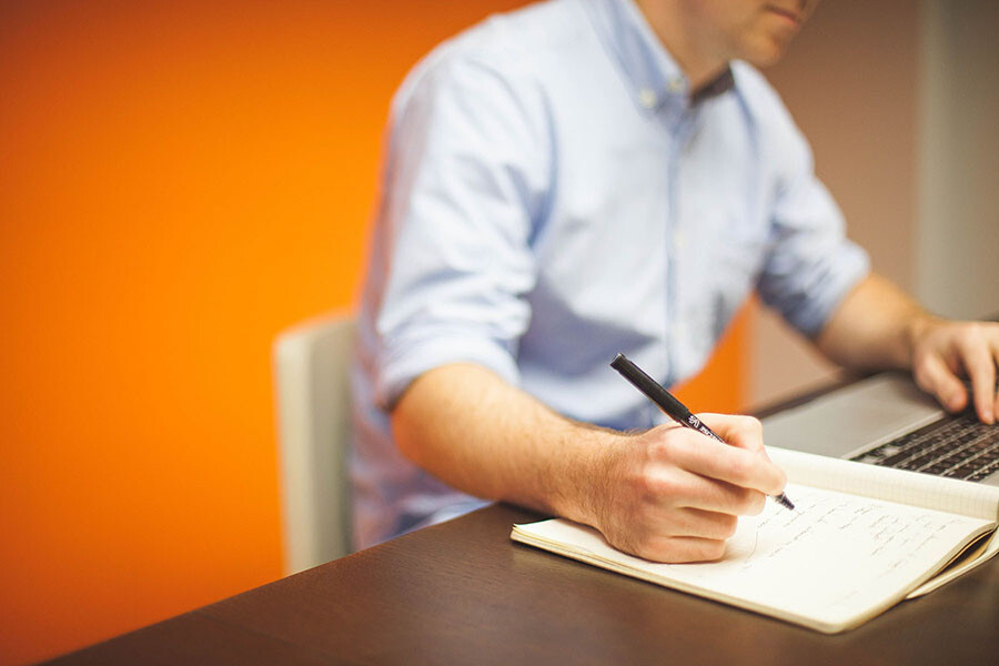 businessman typing on a notepad