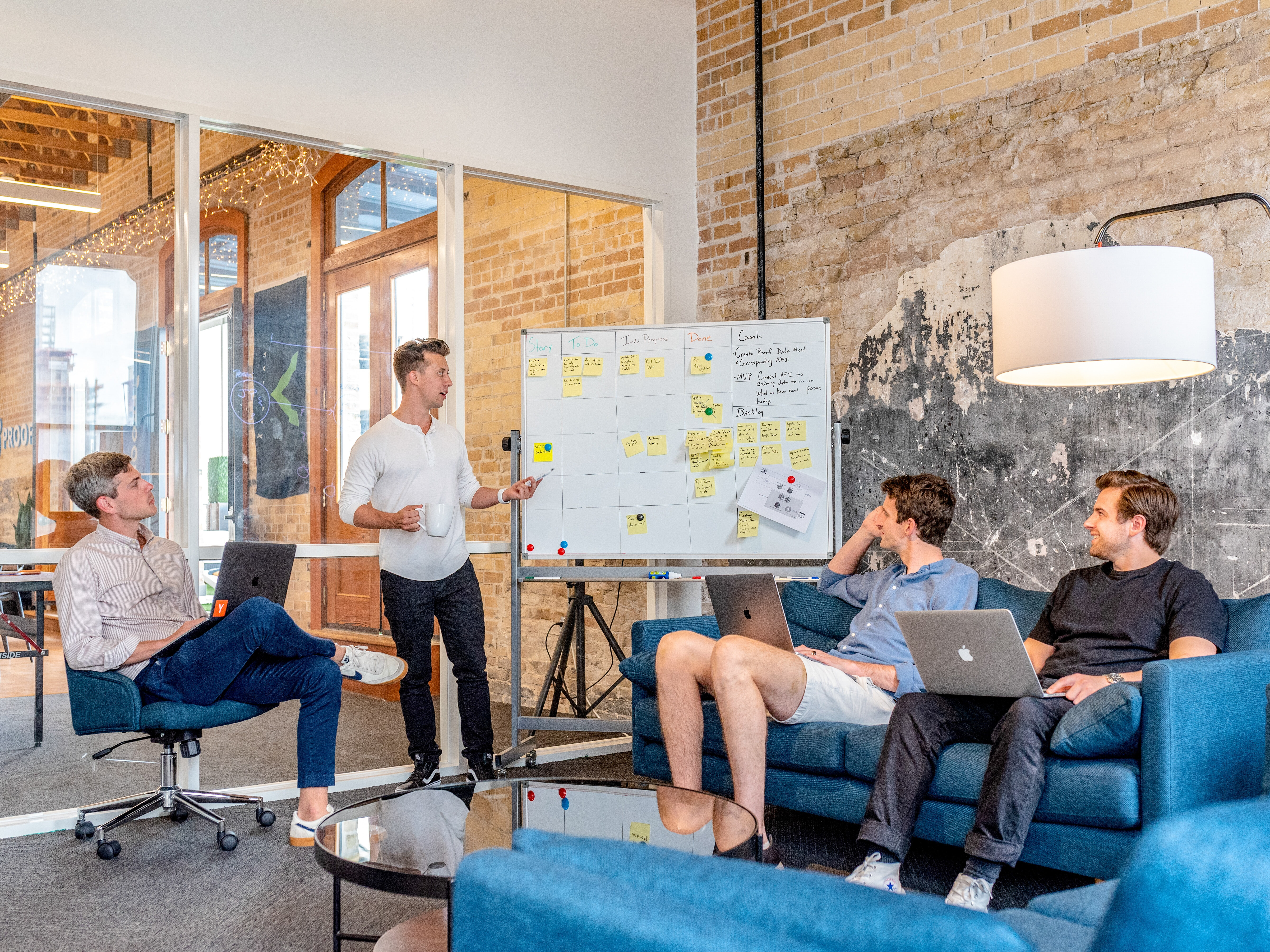 group of business professionals around a whiteboard