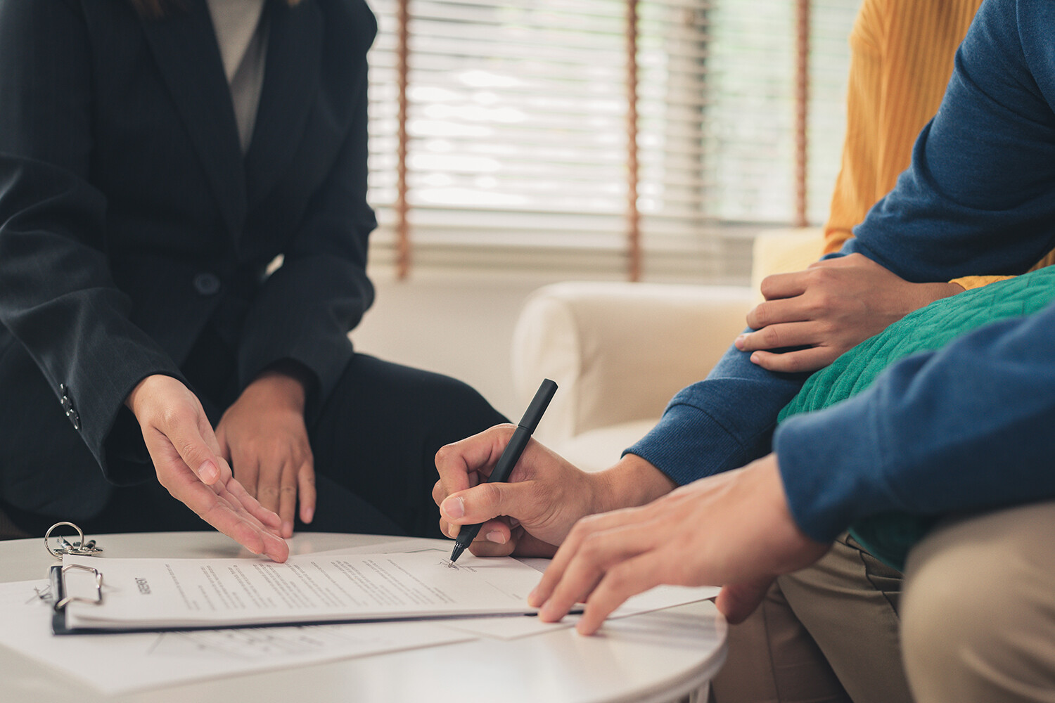 Two people signing insurance policy