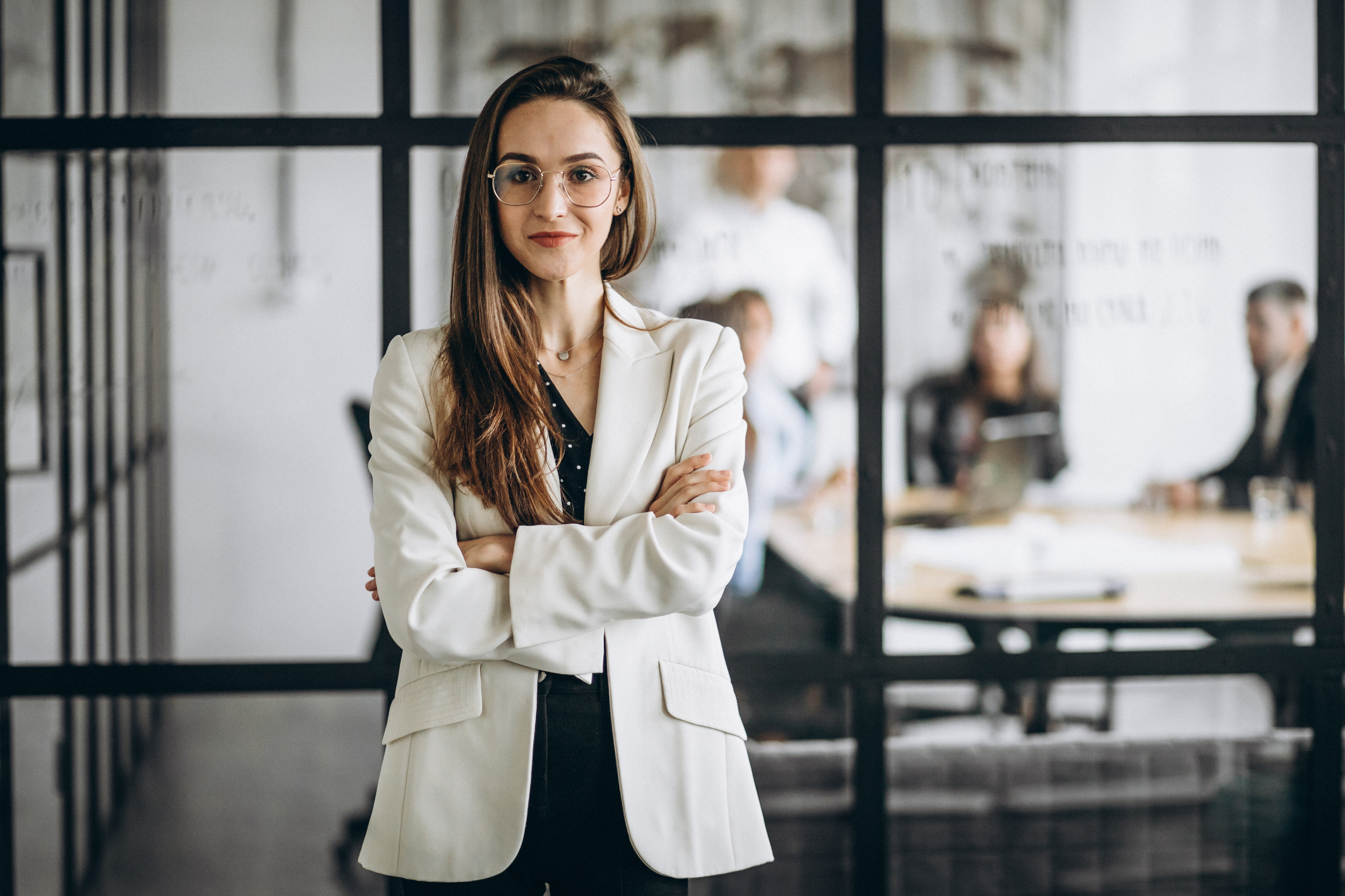 A businesswomen standing with their arms crossed