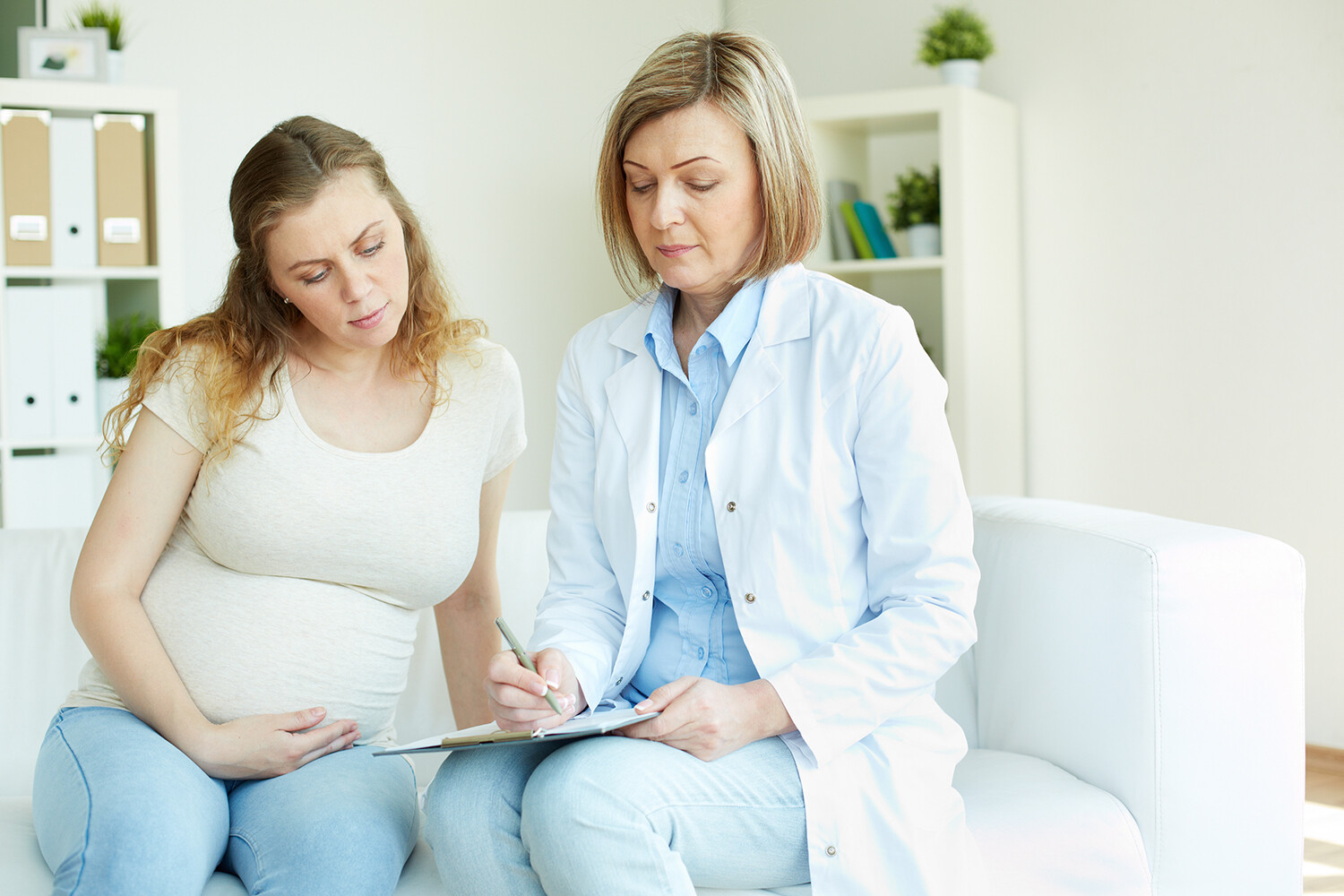 Pregnant woman with doctor