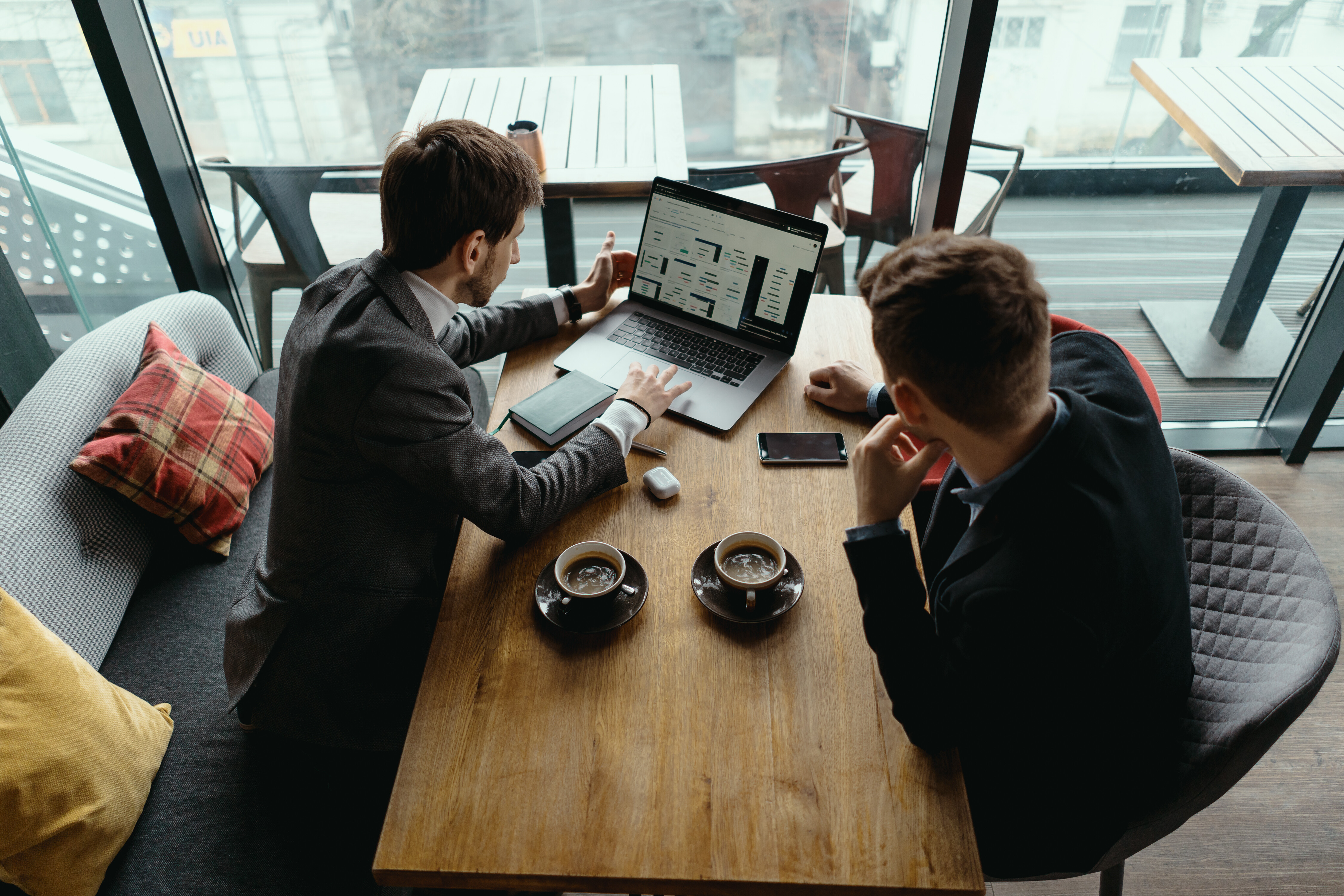 two professionals working on a computer 